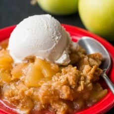 Apple crisp served on plate with ice cream