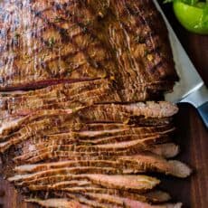 Sliced carne asada on cutting board