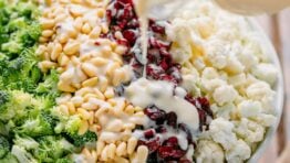 broccoli cauliflower salad drizzled with creamy dressing