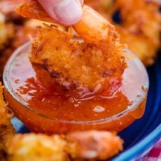 Dipping coconut shrimp in sauce