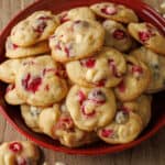 White chocolate cranberry cookies stacked on a red platter