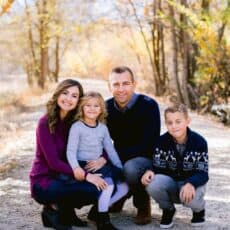 Natasha Kravchuk and with husband and two children posing for the camera.