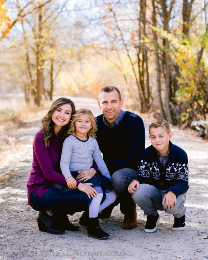 Family crouching down and smiling