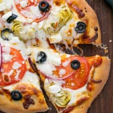 A pizza sitting on top of a wooden cutting board