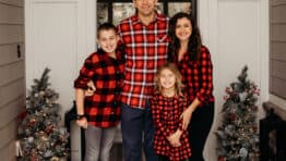 Family smiling at front door