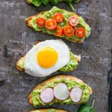 Five varieties of open-faced avocado spread sandwiches