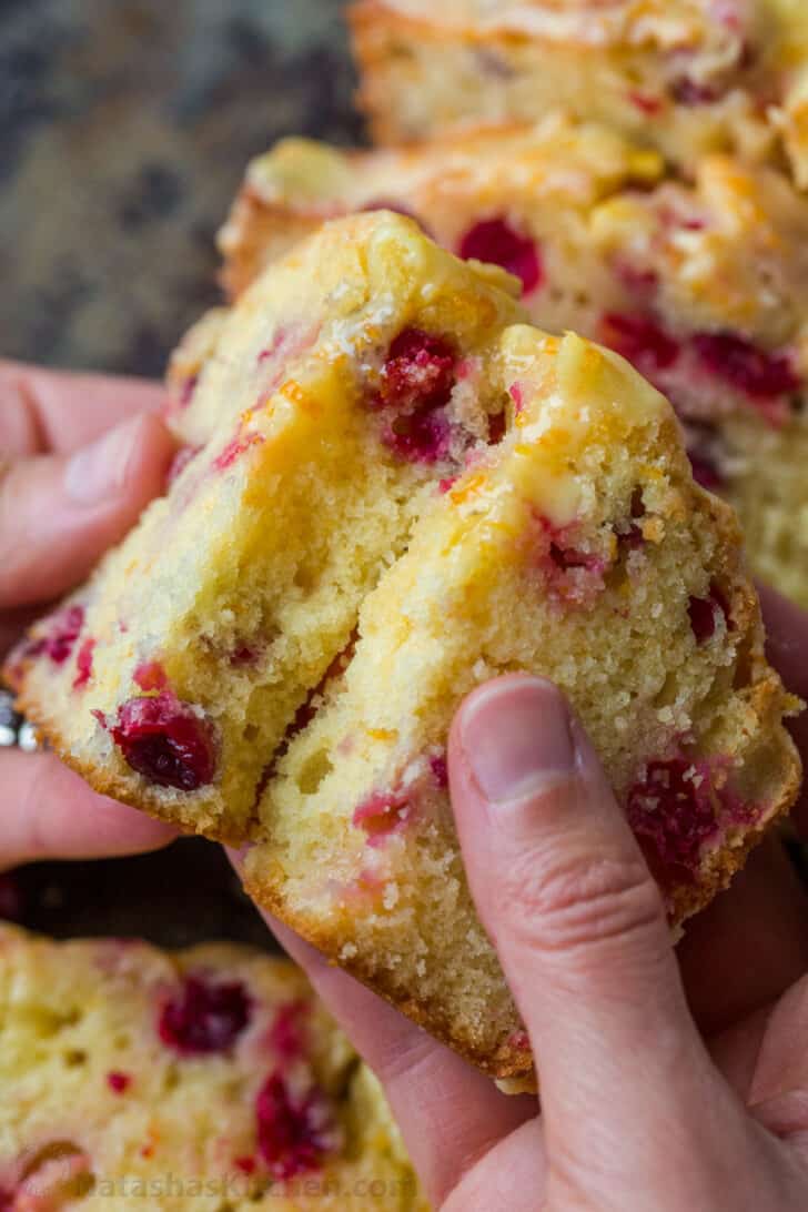 Slice of cranberry bread broken in half to show tender center