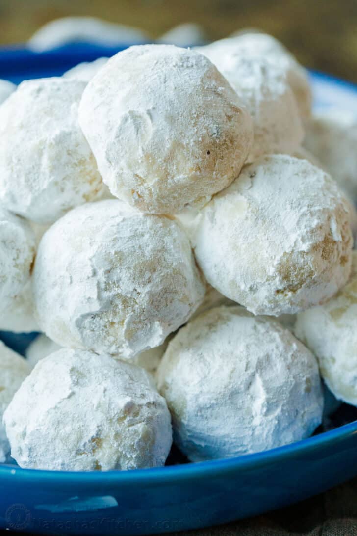 Russian tea cakes served on a blue plate