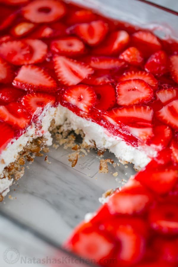 Pretzel salad sliced in a casserole dish showing layers of the pretzel salad