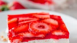 This strawberry pretzel salad is always a hit at parties. It's a strawberry jello dessert that is dangerously good! It's sweet, salty, tart and irresistible!