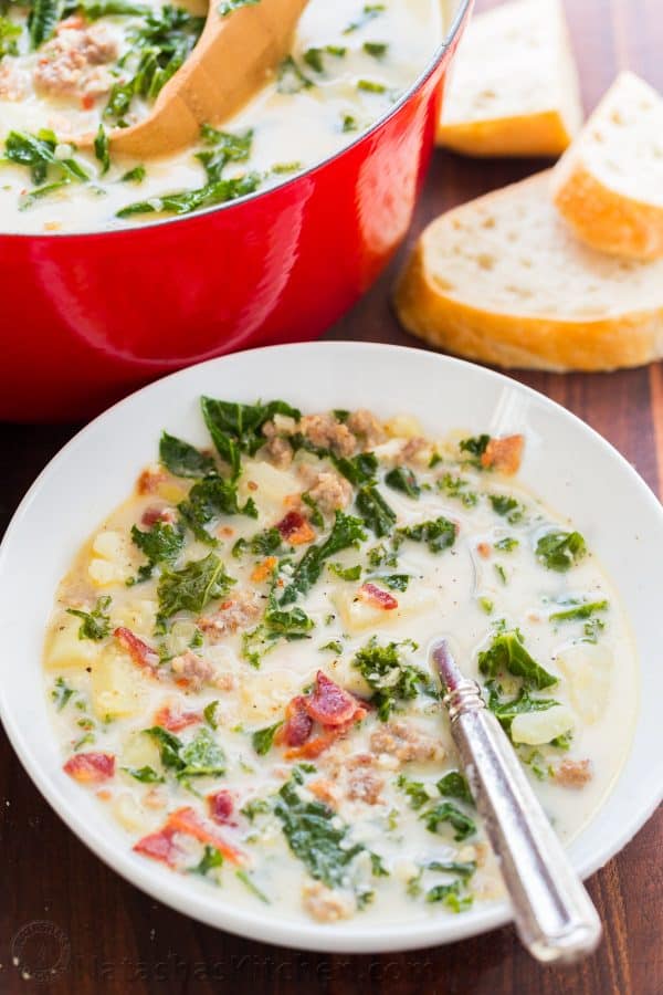 Zuppa toscana soup served in bowl next to pot of soup